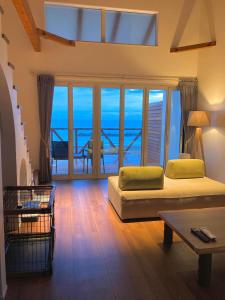 a bedroom with a bed and a view of the ocean at Love&Peace Resort in Shima