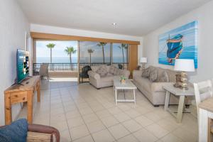 a living room with a view of the ocean at Oceanfront Sunsets at Sonoran Spa E305 in Puerto Peñasco