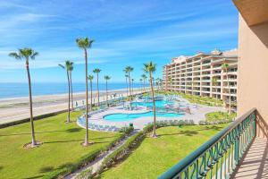 a view of the beach from the balcony of a resort at Oceanfront Sunsets at Sonoran Spa E305 in Puerto Peñasco