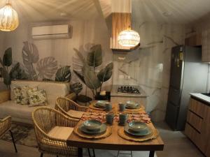 a kitchen and living room with a table and a couch at Casa Yireth in Ricaurte