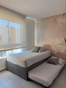 a bedroom with a large bed and a window at Casa Yireth in Ricaurte +21 photos