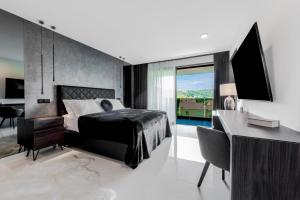 a bedroom with a bed and a desk with a computer at Luxury Villa Black Cube with Heated pool in Mlini +45 photos