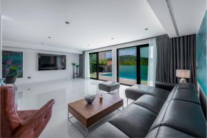 a living room with a couch and a table at Luxury Villa Black Cube with Heated pool in Mlini