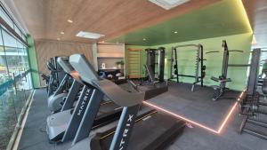 a gym with several tread machines in a room at Beach Class Verano 214 C in Ipojuca