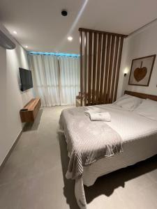 a bedroom with a large bed and a large window at Beach Class Verano 214 C in Ipojuca +19 photos