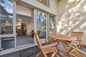 a patio with a table and chairs on a porch at Inala 2 in Thredbo
