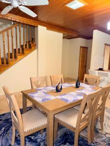 a dining room with a wooden table and chairs at 4 story Ocean Villa in Nassau +30 photos