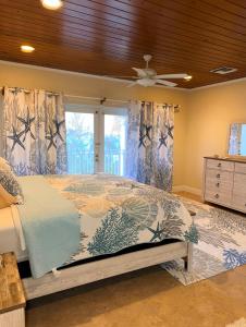 a bedroom with a bed and a ceiling fan at 4 story Ocean Villa in Nassau
