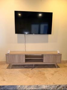 a large flat screen tv on a wall at 4 story Ocean Villa in Nassau