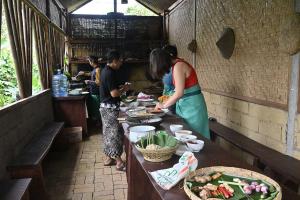 a group of people preparing food on a table at Livin didesa in Munduk