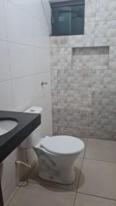 a bathroom with a toilet and a sink at Palace Hotel in Anápolis