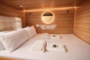 a bed in a room with two towels on it at Wink at Upper Cross Street in Singapore +38 photos