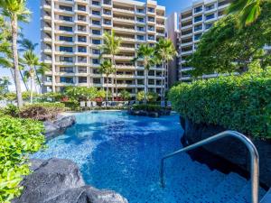 a swimming pool in front of a large building at Kaanapali Alii 2 Bedroom Ocean View in Kaanapali