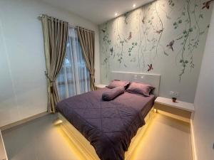 a bedroom with a purple bed and a window at RV-Villa 4 bedrooms&Private Pool in Pulau Sembakau Kecil +26 photos