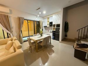 a living room with a table and a couch at RV-Villa 4 bedrooms&Private Pool in Pulau Sembakau Kecil