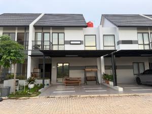 a white house with a bench in front of it at RV-Villa 4 bedrooms&Private Pool in Pulau Sembakau Kecil