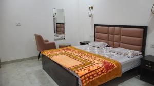 a bedroom with a large bed and a mirror at Shivganga viila in Varanasi