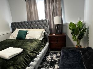 a bedroom with a bed with a gray headboard at apartment unit in Spokane