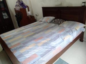 a large bed with a wooden frame in a bedroom at ADOBE AFFECTIOn in Tangalle