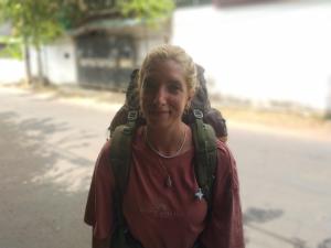 a woman is walking down the street with a person at ADOBE AFFECTIOn in Tangalle