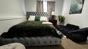 a bedroom with a bed with a black comforter at apartment unit in Spokane +9 photos