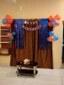 a curtain with a happy birthday sign and balloons at Limra Farm House in Pollāchi +25 photos
