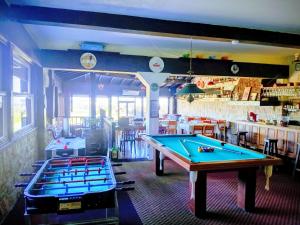 a room with two pool tables in a restaurant at Hostal del Sur in Mar del Plata