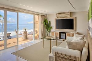 a living room with a view of the ocean at LIME Resort Bohol, a member of Radisson Individuals Premier in Panglao Island
