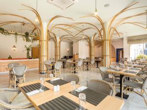 a restaurant with tables and chairs and a bar at Ibis Fes in Fez