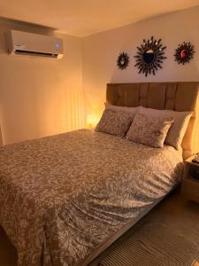 a bedroom with a bed and two mirrors on the wall at Casa Bella Apartamentos in Cali