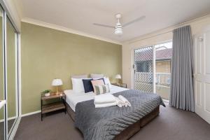 a bedroom with a large bed and a window at Surfers Tradewinds in Gold Coast +37 photos