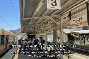 a train station with people waiting for a train at Riverside Oasis WAKUWAKU-BASE in Yabuhara +68 photos