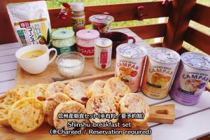 a table with bread and cans of food and drinks at Riverside Oasis WAKUWAKU-BASE in Yabuhara