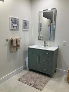 a bathroom with a sink and a mirror at Luxury oceanfront escape in Neguac +8 photos