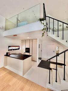 a kitchen and living room with a spiral staircase at Casa Verta in Skrad