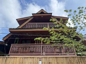 a house with a balcony on top of it at Leianna House in Itaytay