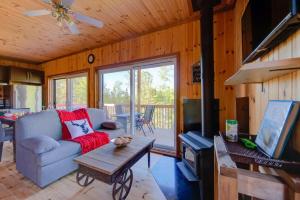 a living room with a couch and a table at L'Enchanteur - Private Spa & Pet Friendly in Pohénégamook