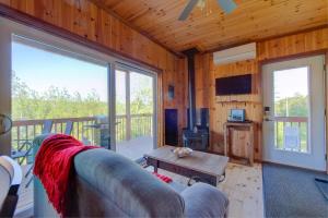 a living room with a couch and a table at L'Enchanteur - Private Spa & Pet Friendly in Pohénégamook