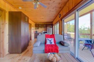 a living room with a blue couch and a kitchen at L'Enchanteur - Private Spa & Pet Friendly in Pohénégamook +28 photos