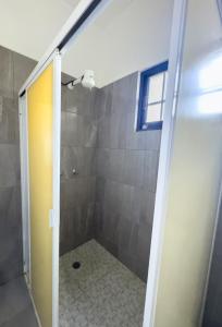 a bathroom with a shower with a glass door at Casa San Luis in Tuxtla Gutiérrez +9 photos