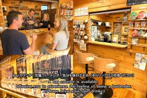 a man and a woman sitting at a counter in a store at Riverside Oasis WAKUWAKU-BASE in Yabuhara