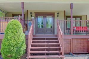 a house with a wooden staircase leading to the front door at L'Escapade - Spa billard & foyer in Petite-Rivière-Saint-François