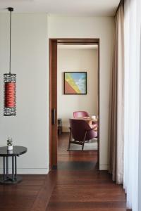 a hallway with a door leading to a dining room at Ananti at Busan Cove in Busan