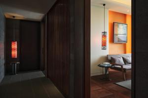 a hallway with a door leading into a room with a couch at Ananti at Busan Cove in Busan +107 photos