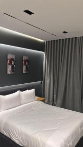 a bedroom with a white bed and a curtain at Crown Mountain in 6th Of October