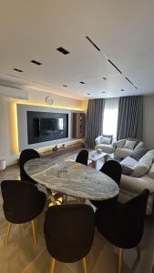 a living room with a table and chairs and a couch at Crown Mountain in 6th Of October