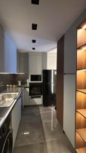 a large kitchen with stainless steel appliances in it at Crown Mountain in 6th Of October