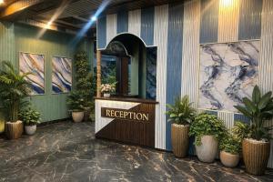 a reception area of a hotel with potted plants at Lake side stays in Srinagar