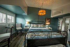 a bedroom with a bed with a blue wall at Dungeness Barn House Bed and Breakfast at Two Crows Farm in Sequim