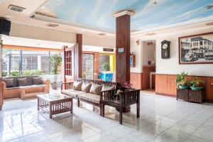 a living room with a couch and a table at Rehat at Hotel Sabang in Bandung